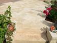 Photo client : les dalles en travertin Medium Select, finition tambourinée, en format opus romain, posées sur une terrasse, vue sur escaliers et parterres de fleurs