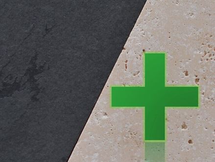 Pierre naturelle claire à côté de la pierre naturelle foncée, sur laquelle se trouve une croix verte