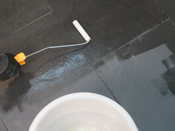 L'imprégnation est appliquée sur la pierre posée à l'aide d'un rouleau.