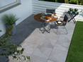Table de petit-déjeuner sur une terrasse avec des carreaux modernes en grès cérame à l'aspect d'ardoise